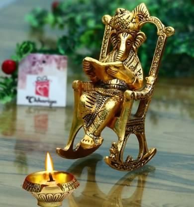 Golden Lord Ganesha Statue Sitting On A Rocking Chair And Reading Ramayan Showpiece